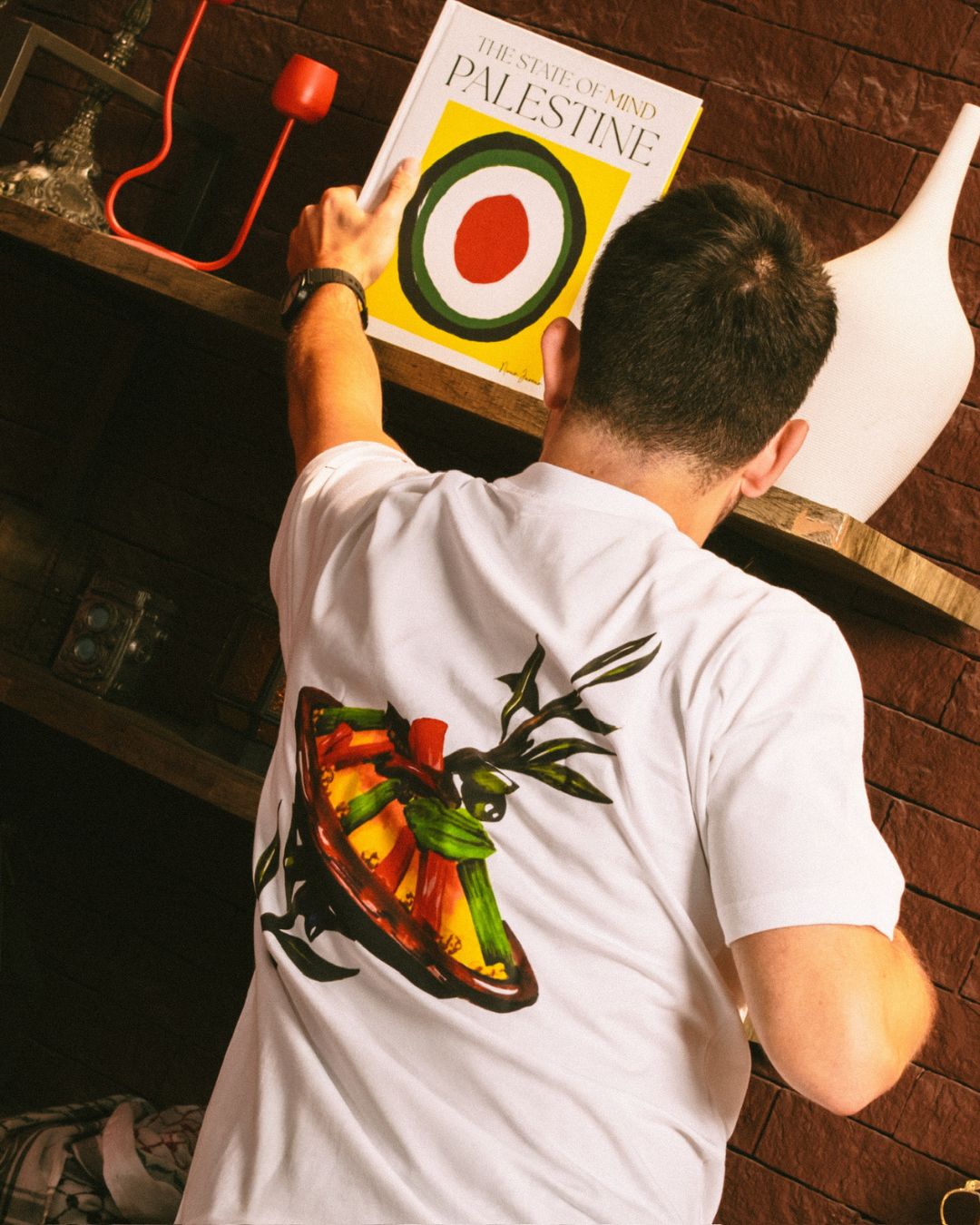 model wearing tshirt with couscous dish artwork